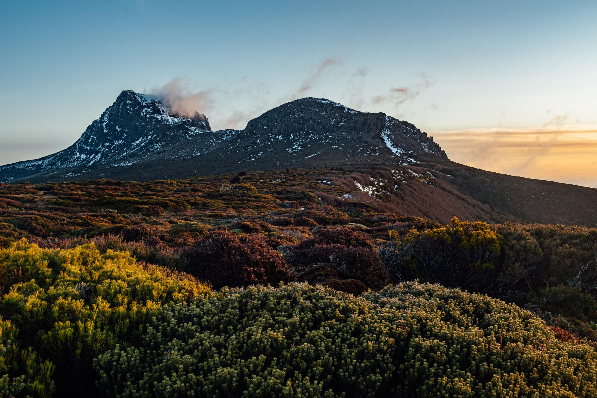 Cradle Mountain-St Clair National Park, visit cradle mountain Misty clouds rolling over the rugged dolerite peaks of Cradle Mountain-St Clair National Park.